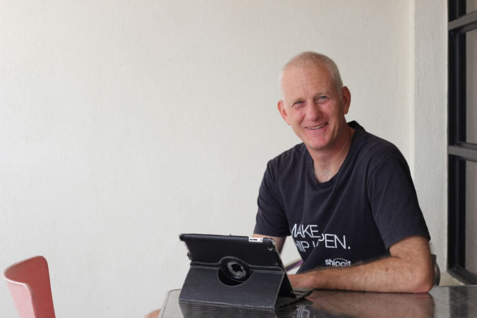 Colin Clapp sitting on balcony with iPad