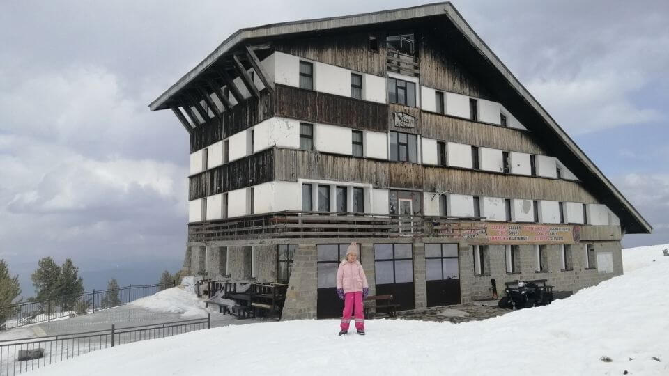 Things to do in Bansko Bulgaria-Bezbog hut-wintertime-Ayla in front