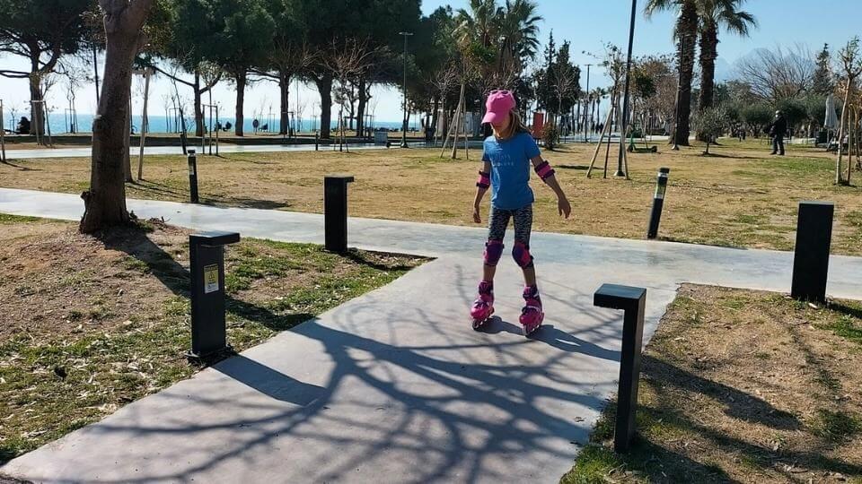 Ayla roller blading on the Konyaalti beach waterfront-hang out here if you are looking for things to do in Antalya with kids