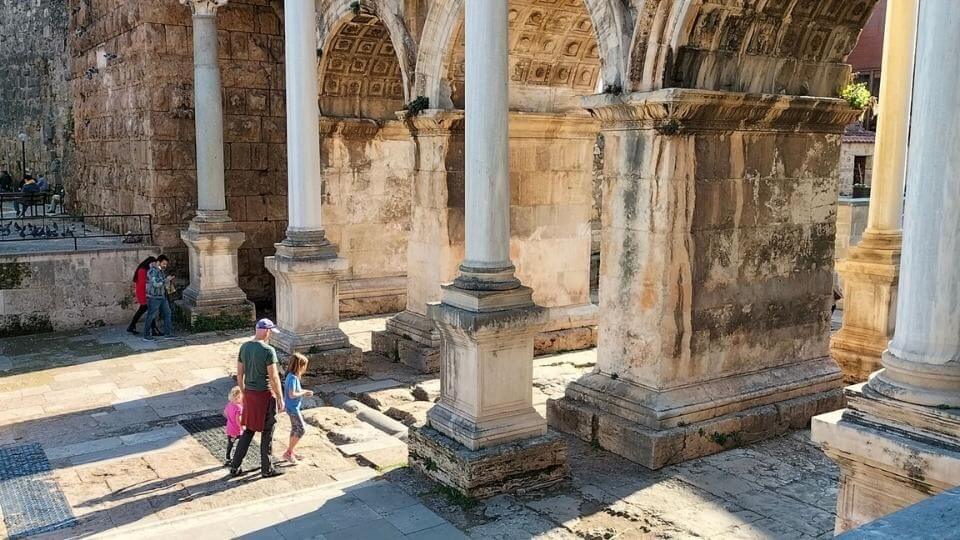 Colin, Ayla, and Romy walking through Hadrian's gate, the entrance to Antalya's old town