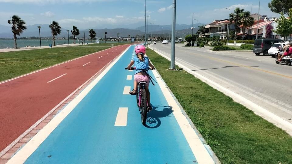 Ayla riding her bike along the Fethiye to Calis waterfront path
