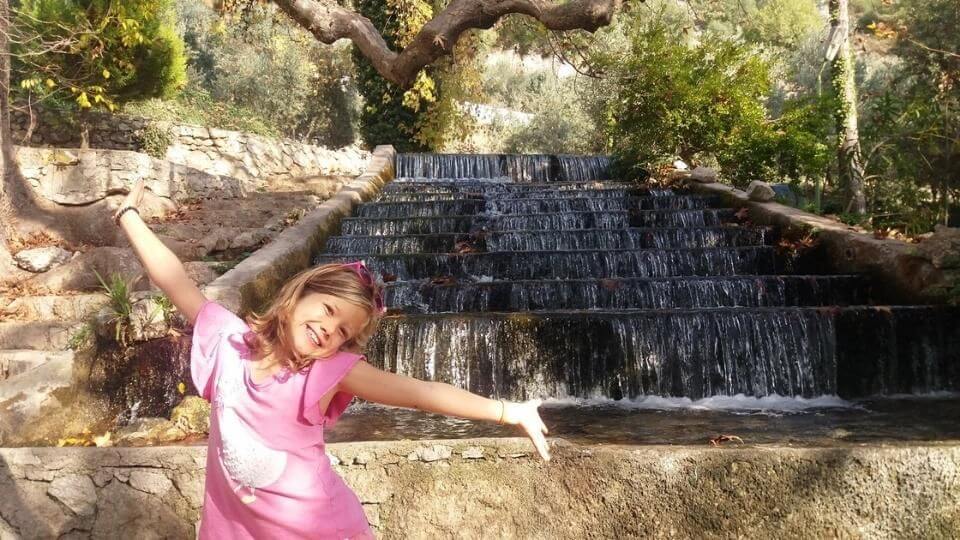 Ayla standing in front of a waterfall at Yaka park near Fethiye in Turkiye