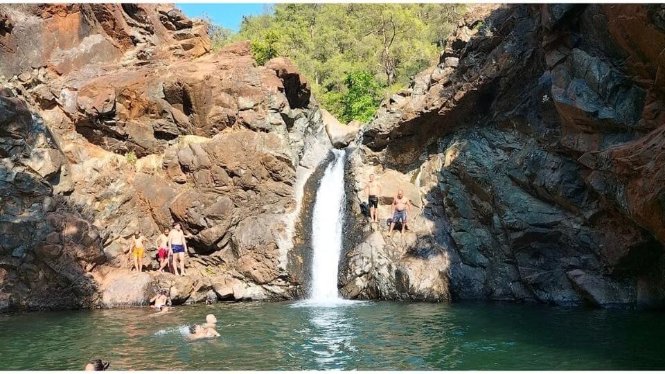 People climbing the rocks and swimming in the cool water at Toparlar waterfall near Dalyan