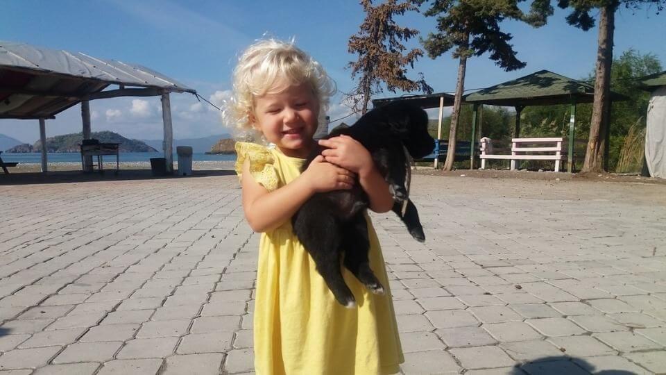 Romy holding a cute puppy at Karaot beach