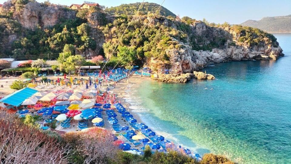 Spend a day at the beach swimming amid clear blue water and a shot walk from Kas