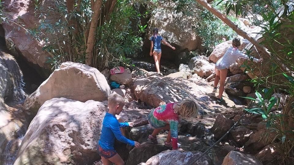 Take the boat from Oludeniz to butterfly valley if you're looking for things to do in Fethiye-kids rock climbing on waterfall walk