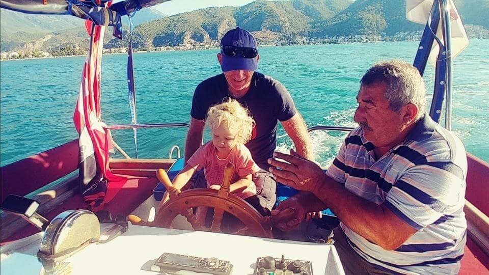 Things to do in Fethiye-ridee the water taxi-Romy driving the boat with daddy
