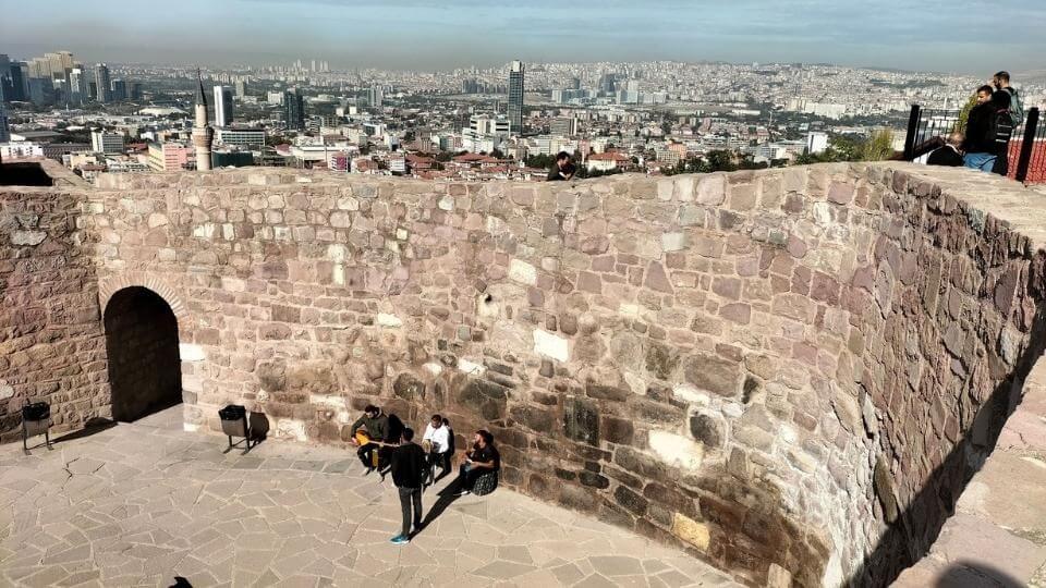 A view looking down on musicians at the Ankara castle and a sweeping view of the city beyond