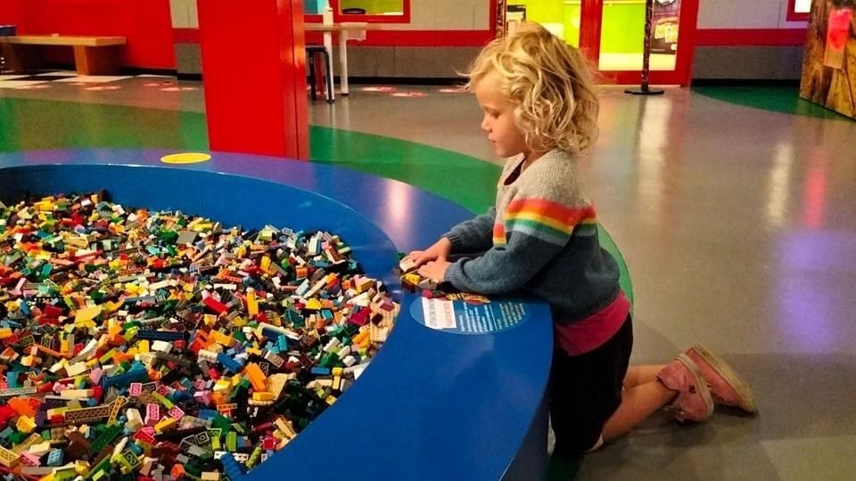 Romy kneeling beside a lego pit at Legoland in Istanbul