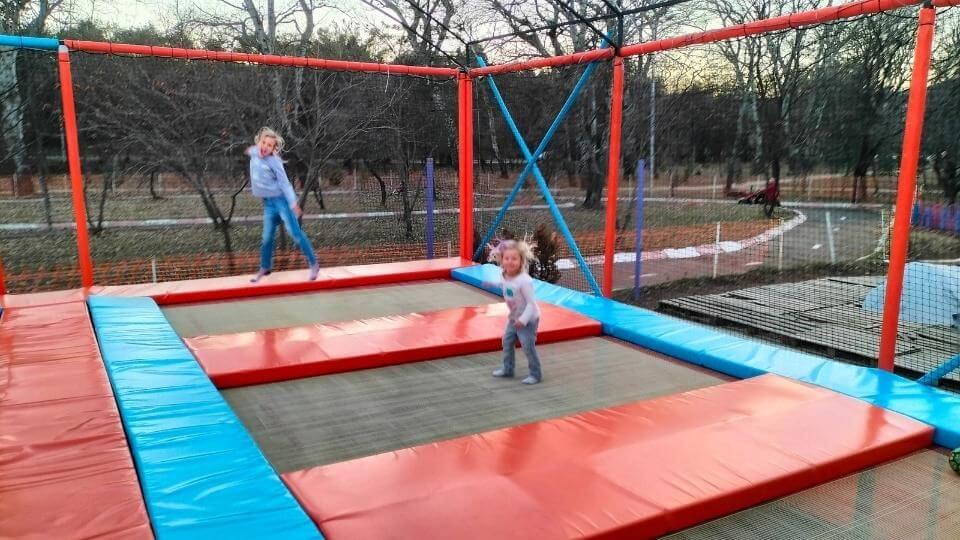 Ayla and Romy jumping on trampolines at Lisi beach in Tibilisi