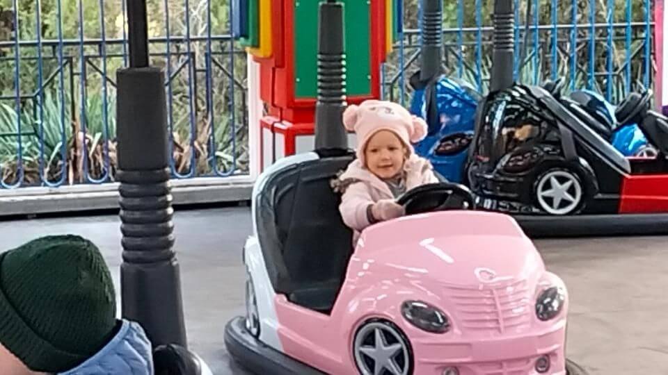 If you're looking for things to do with kids in Tibilisi, take them to Mtatsminda park - Romy driving a pink bumper car