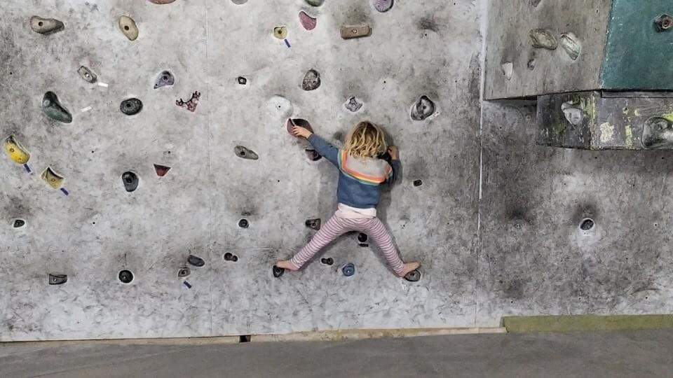 Romy climbing an indoor bouldering wall in Tibilisi