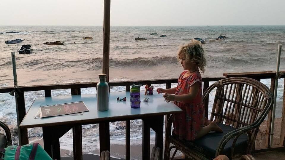 Romy at a beachfront restaurant in Anjuna, North Goa, during high tide.