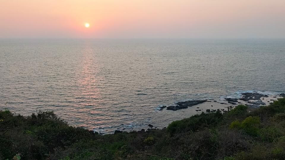 Walk over the hill at the south end of Anjuna to watch the sunset
