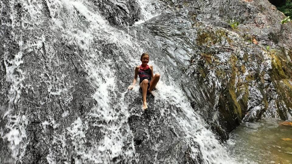 Ayla sitting in a waterfall at Gunung Pulai recreational reserve in Johor