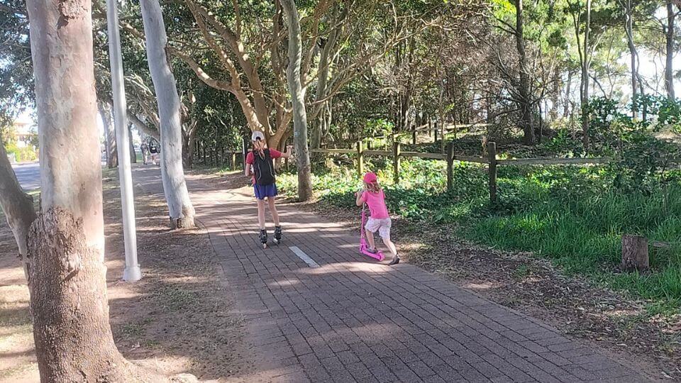 Ayla on her roller blades and Romy on a scooter along the Hervey Bay Esplanade.