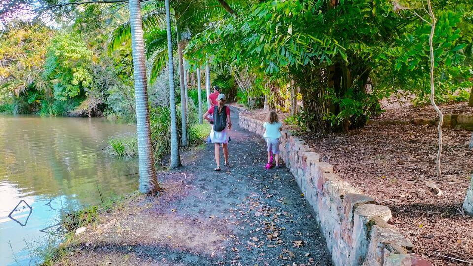 Colin, Ayla, and Romy walk along a path in the Hervey Bay Botanic Gardens, a perfect spot to stroll and look at turtles.