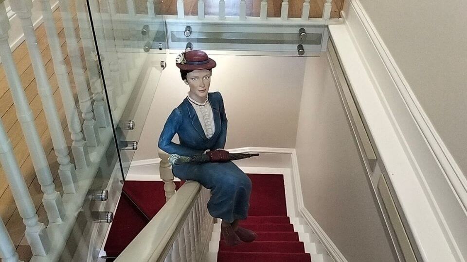 A Mary Poppins replica sits on the stairway bannister at The Story Bank in Maryborough.