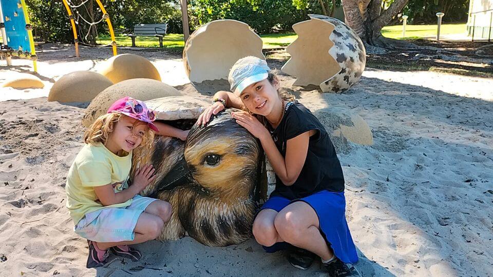 Ayla and Romy wth a baby duck sculpture at Point Talburpin Park Playground in the Redlands.