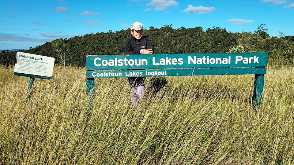 Ayla stands behind the sign for the lookout at Coalstoun Lakes National Park, a nice hike near Bundaberg.
