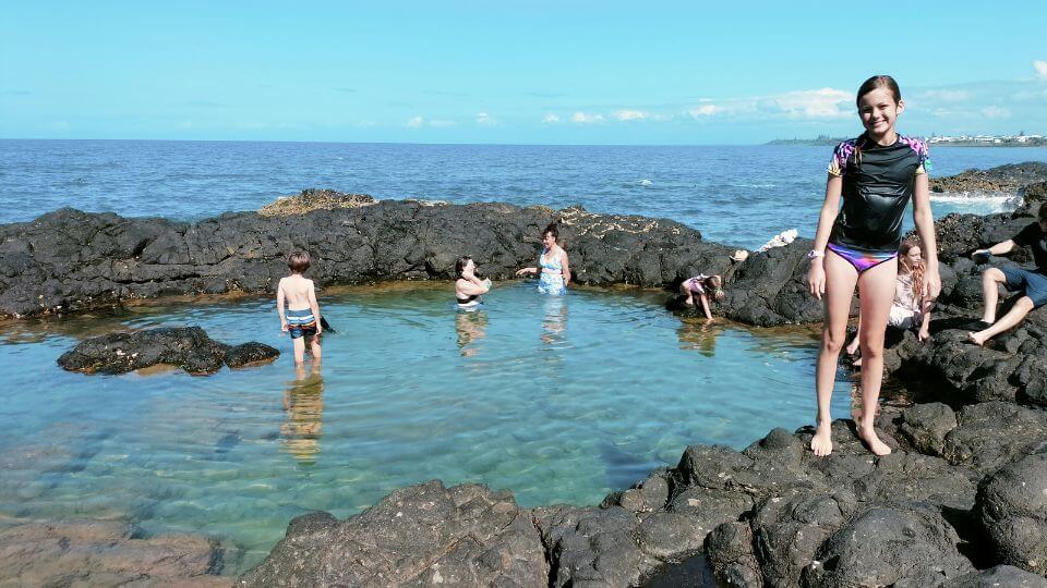 Ayla stands in front of one of the idyllic rock pools at Barolin Rocks, a dive site near Bundaberg.