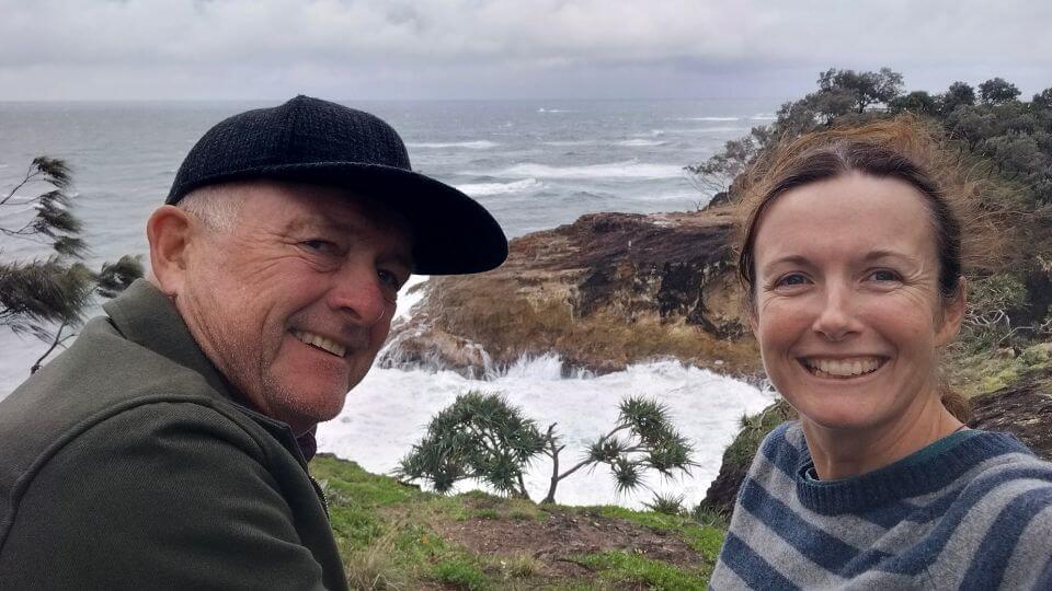 Elly and her dad on the North Gorge Walk on Stradbroke island, with the raging sea behind.