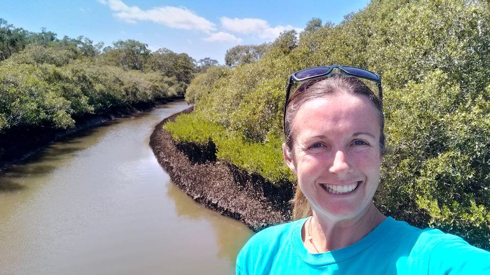 Elly takes a selfie in front of the Lota Creek while walking the Lota Creeek boardwalk and circuit.