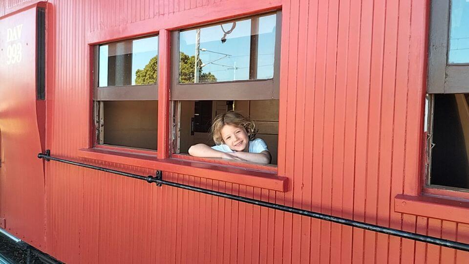 Romy looking out a train window at the Bundaberg Railway Museum.