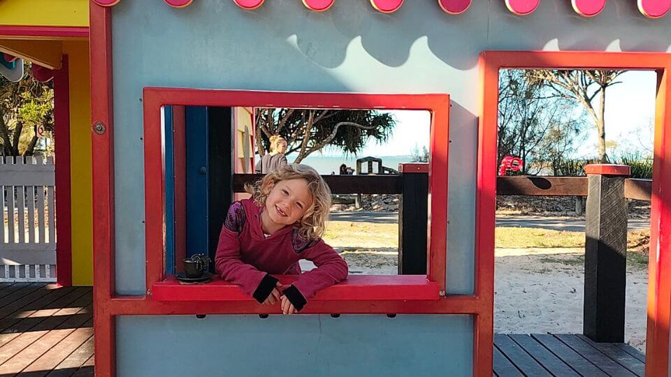 Romy looking out of one of the play houses at Whale Park Wynnum on Brisbane's Bayside.