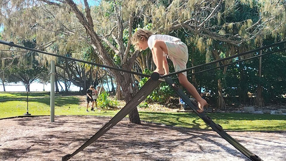 Romy on a climbing frame at Schuhkraft Park Playground in Nielson Park.