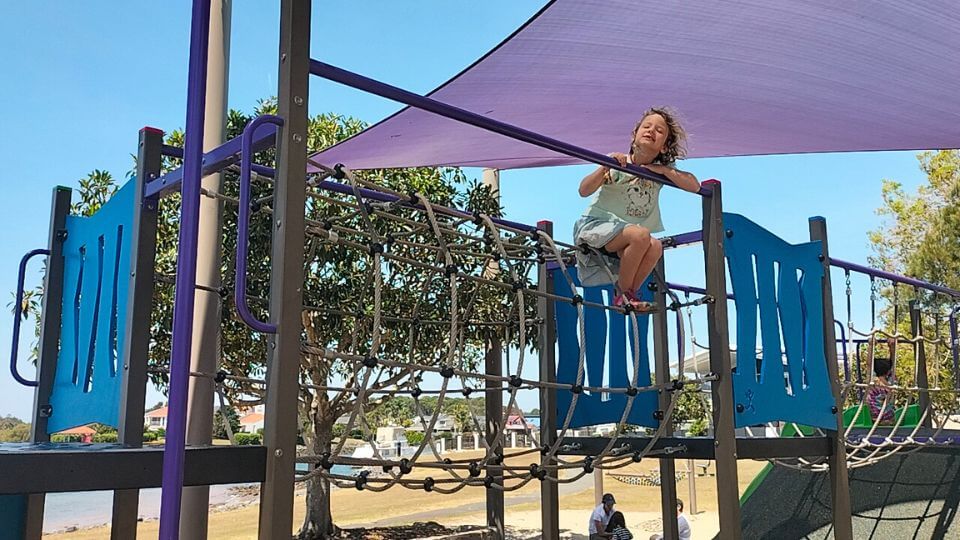 Romy on the play equipment at Aquatic Paradise Park West in Thorneside.