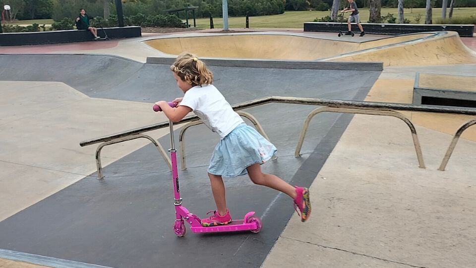 Romy riding her scooter at Walla Street skate park, a good place for kids to burn off energy in Bundaberg.