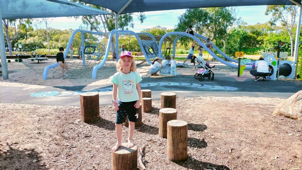Romy stands in front of the playground in Les Moore Park, Victoria Point.