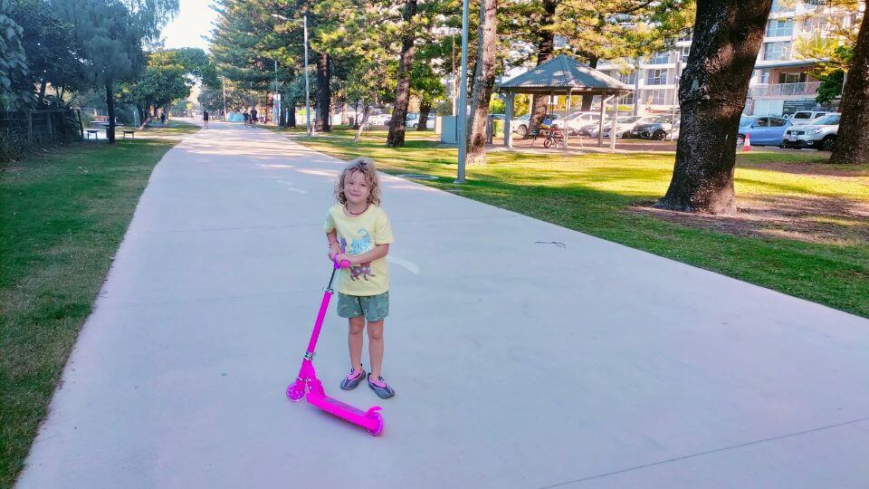 Romy with her scooter on the boardwalk at Burleigh Beach on the Gold Coast.