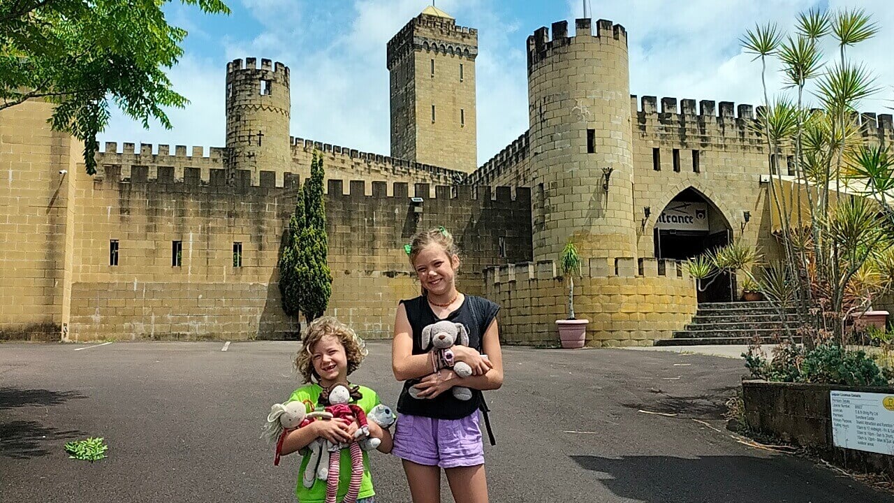 Ayla and Romy stand in front of the Sunshine Castle, a fantastic attraction near Nambour for families.
