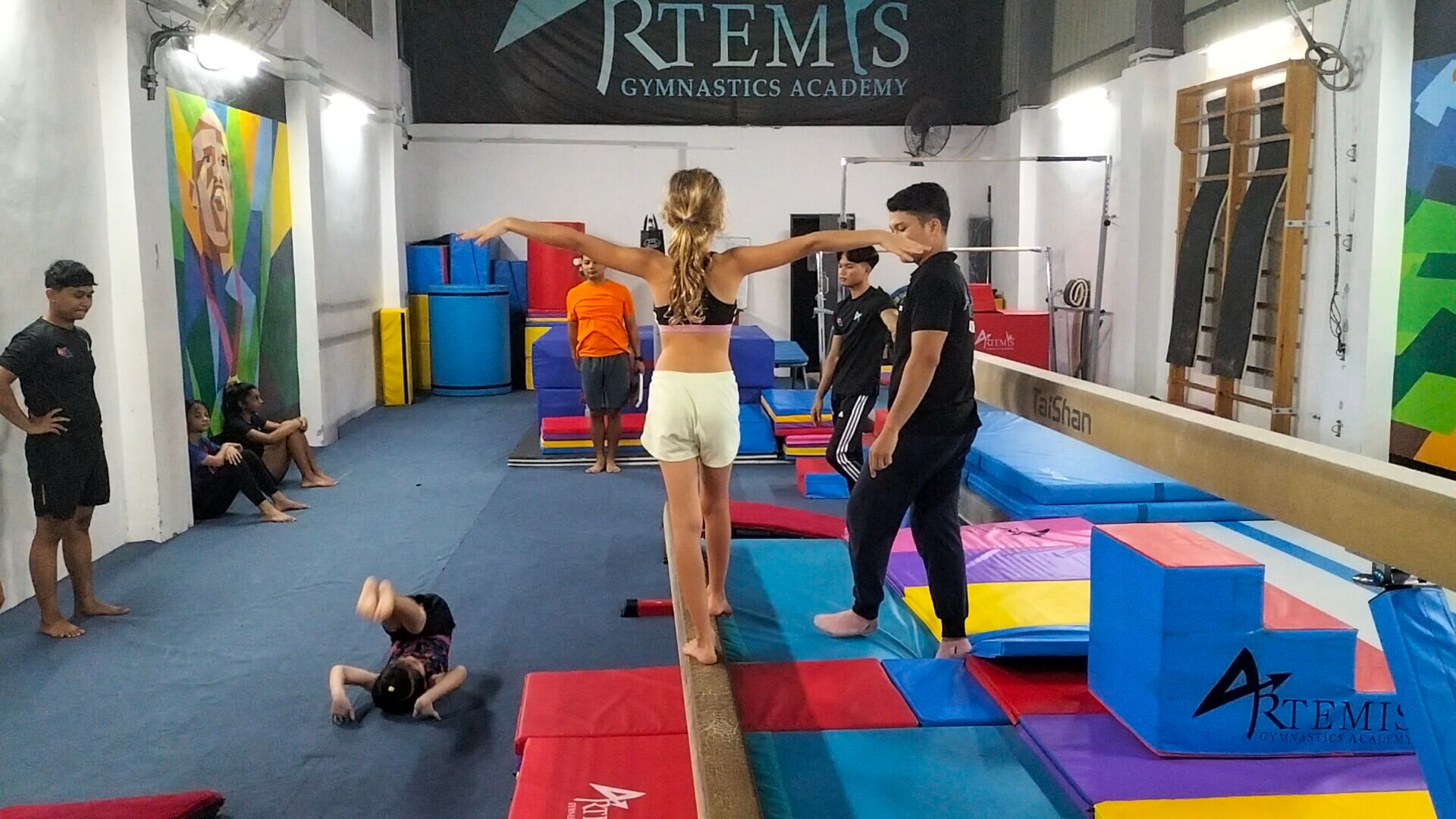 Ayla being coached on the beam at Artemis Gymnastics Academy in Johor Bahru, Malaysia.