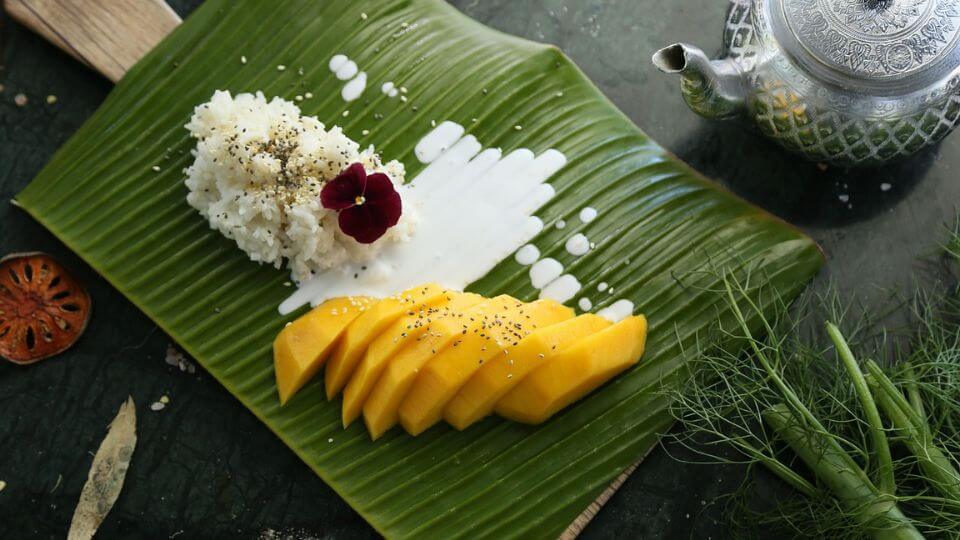 Tasting mango sticky rice is a must-do experience for kids in Bangkok.