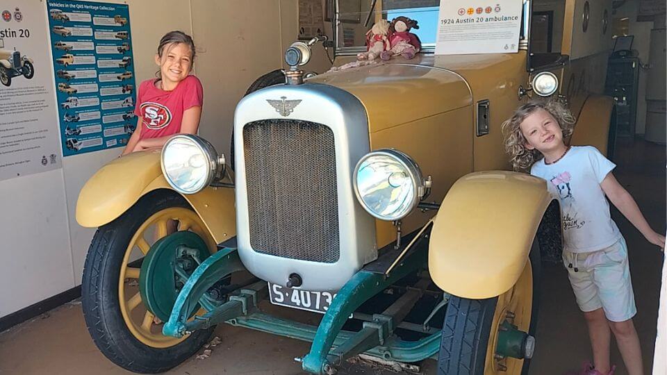 Ayla and Romy beside a vintage vehicle at the Gympie Gold Mining and Historical Museum.