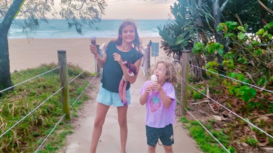 Ayla and Romy eat icecreams at the entrance to Mooloolaba Main Beach.