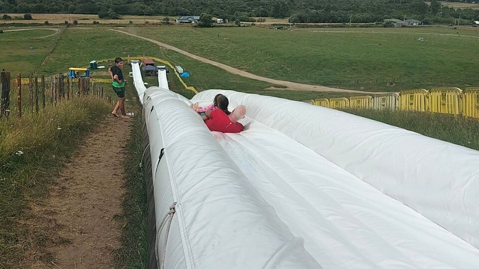 Colin, Ayla and Romy slide down the 150m inflatable waterslide on Mount Ngongotaha in Rotorua.