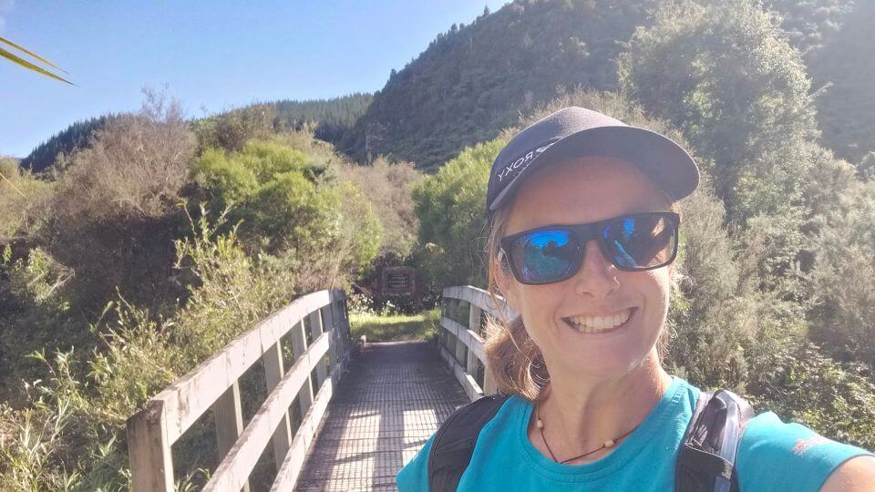 Elly smiles for a selfie on a sunny day near the start of the Tarawera Trail to Hot Water Beach.