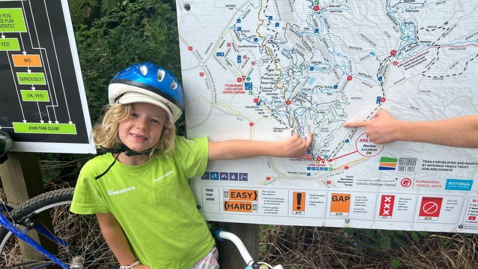 Romy points to the trails she rode on a map at the Whakarewarewa Mountain Bike Park in Rotorua.