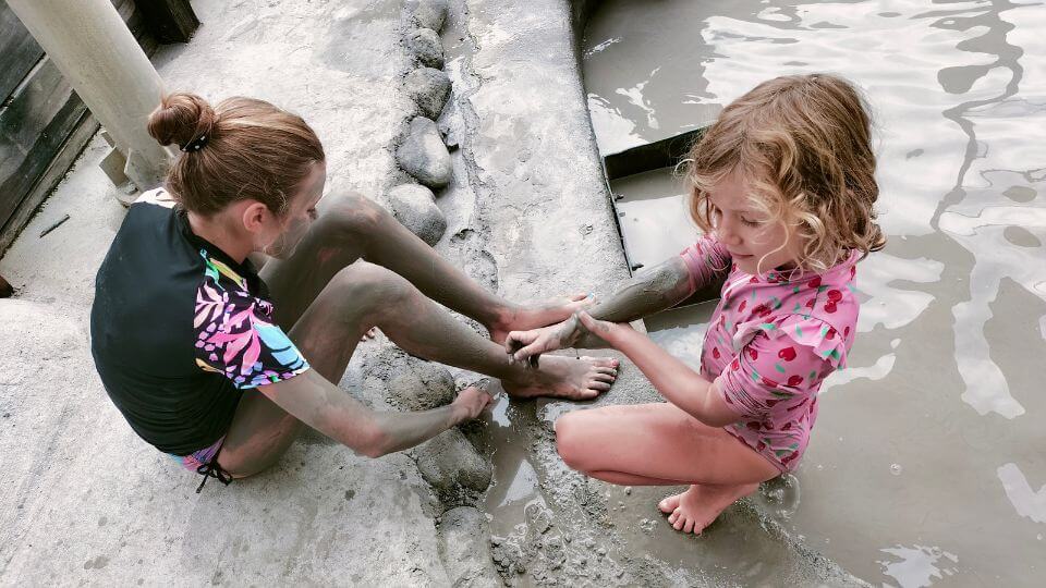 Ayla and Romy enjoy the silky smooth mud at the mud baths at Hell's Gate Geothermal Reserve in Rotorua.