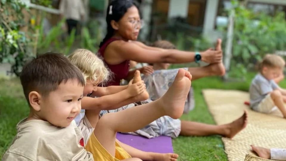 Children participate in a fun yoga session during a four-day family retreat in Bali focused on conscious parenting and healing.