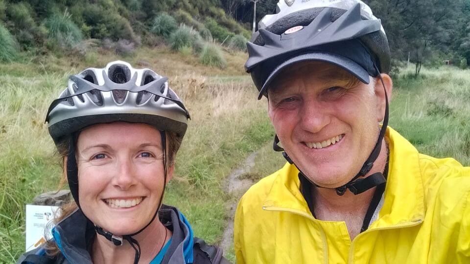 Elly and Colin wearing bike helmets, pictured at the Matokitoki Valley end of the Matokitoki Valley Track in Gisborne.
