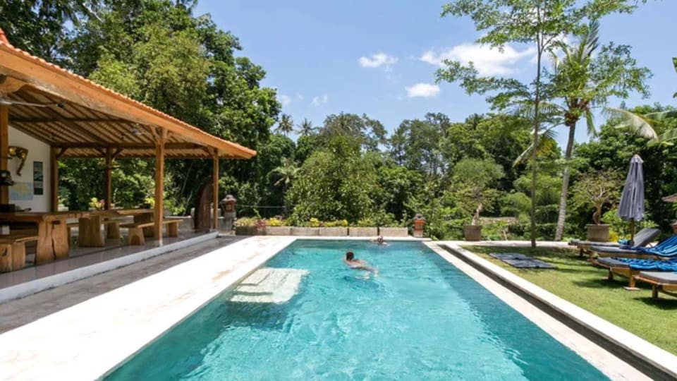 Enjoy plenty of poolside relaxation at Pelan Pelan Bali Surf and Yoga retreat.