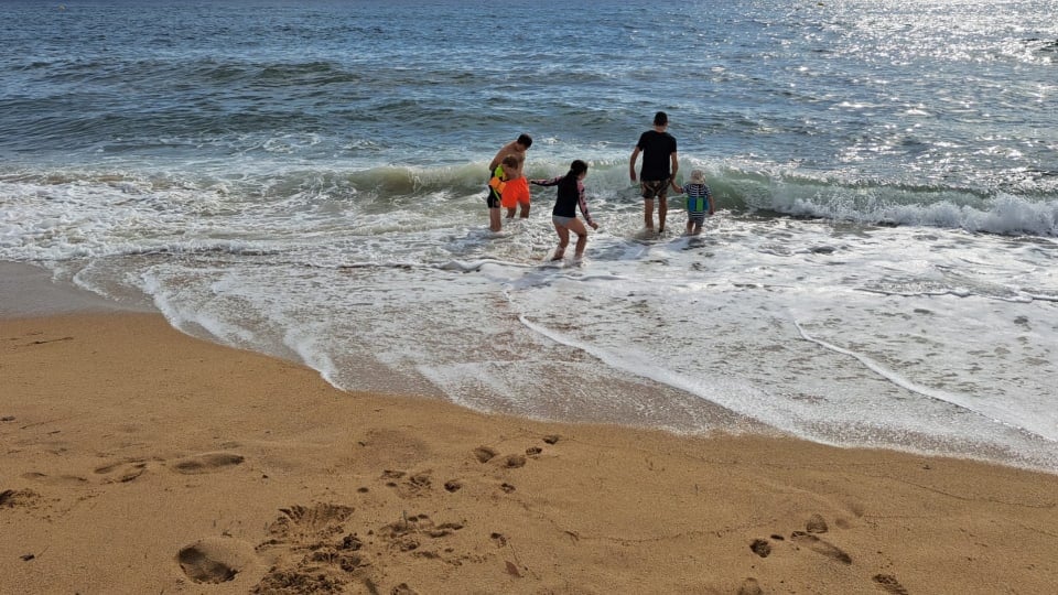 A family of four enjoys beach time at one of Spain's many family-friendly beaches.