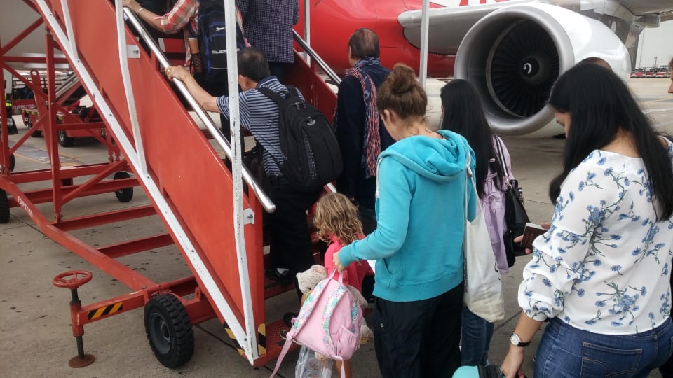 Ayla and Elly boarding an Air Asia plane.