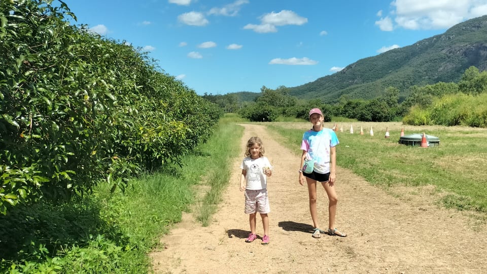 Ayla and Romy at the Achacha Fruit Plantation south of Townsville on a bright, sunny day.