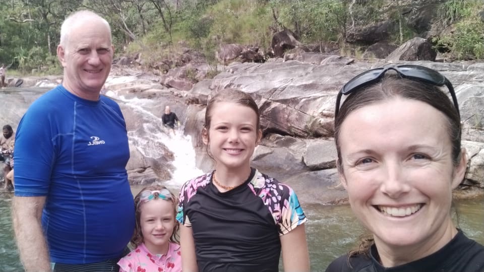 Colin, Romy, Ayla, and Elly at Crystal Creek in the Paluma Range National Park, with one of the rockslides pictured in the background.
